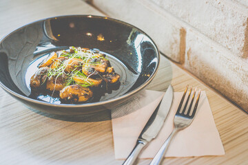Sautéed Mushrooms with butter and herb served in a black dish
