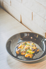 Sautéed Mushrooms with butter and herb served in a black dish