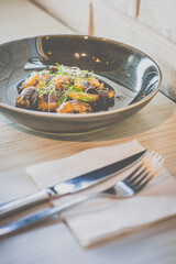 Sautéed Mushrooms with butter and herb served in a black dish
