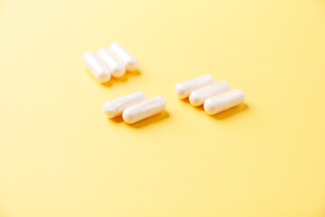 Collagen capsules. Bright paper background. Soft focus. Close up. Copy space.	