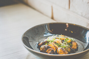 Sautéed Mushrooms with butter and herb served in a black dish