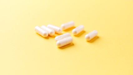 Collagen capsules. Bright paper background. Soft focus. Close up. Copy space.	