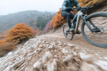 Man is riding a bike on a dirt road with trees in the background