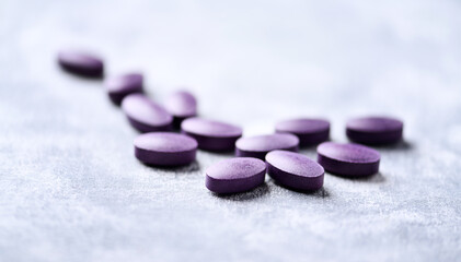 Lutein tablets. Dietary supplement on wooden background. Soft focus. Close up. Copy space	