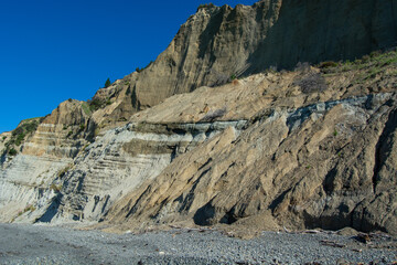 Sedimentary Cliffside Under Clear Blue Sky