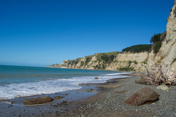 Serene Beach with Rocky Shoreline and Cliffs