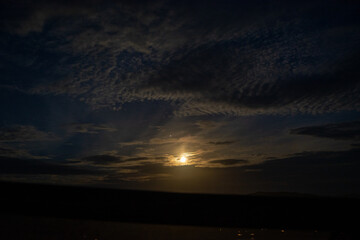 Serene Night Sky with Full Moon and Clouds