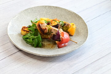 Chicken Skewer with Vegetables and Polenta on a Rustic Plate