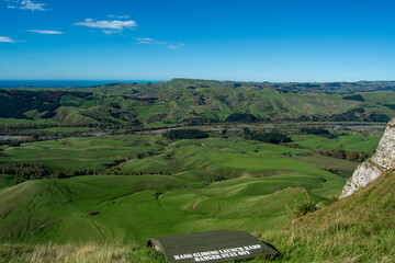 Naklejka premium Panoramic View of Lush Green Hills and River