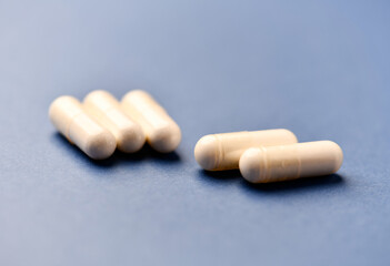 Arginine capsules on bright background. Soft focus. Close up. Copy space.