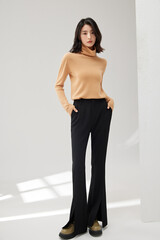 Young Asian woman in stylish outfit with natural pose.