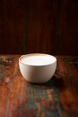 Cappuccino on dark wooden background. Soft focus. Close up.	