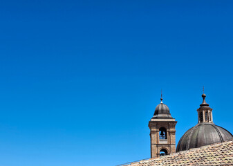 dome and bell tower of the cathedral in Urbino against the blue sky