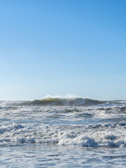 Crashing Pacific Waves under Clear Skies at Ocean Beach, San Francisco, California