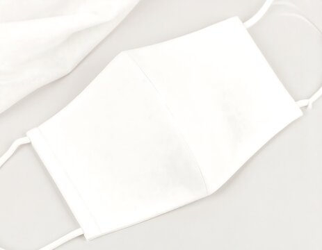 Minimalist white cotton face covering for health, hygiene, and safety during a pandemic. Personal protective equipment concept.