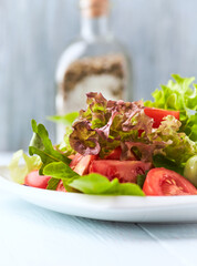 Healthy and tasty salad with tomatoes, olives, cucumber, and lettuce.