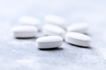 Amino acids tablets on wooden background. Soft focus. Close up	
