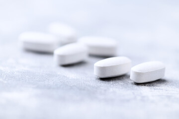 Amino acids tablets on wooden background. Soft focus. Close up	