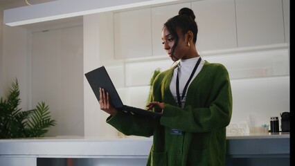 Focused diverse people working at modern startup office. young professional woman stands...