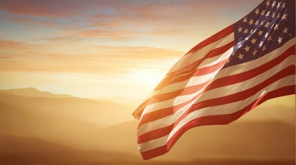 The waving American flag illuminated by a beautiful sunrise over mountains.