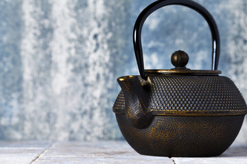 Japanese Cast Iron Teapot on bright background.	