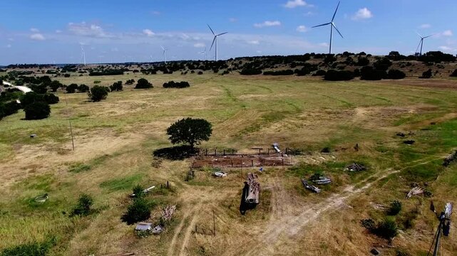 Wind turbine farm in a rural texas landscape with blue sky and clouds