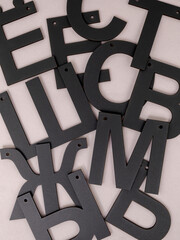 A set of black letters from a Russian dictionary on a gray background are scattered chaotically
