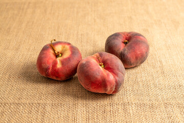 Sweet fig peaches on jute cloth, macro.