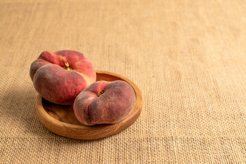 Sweet fig peaches on jute cloth, macro.