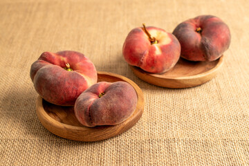 Sweet fig peaches on jute cloth, macro.