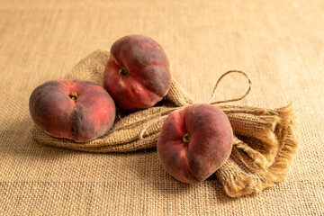 Sweet fig peaches on jute cloth, macro.