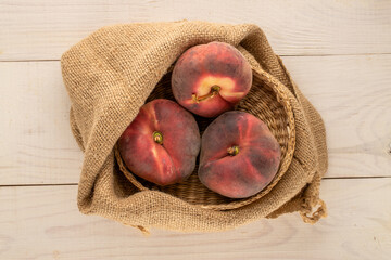 Sweet fig peaches on a wooden table, top view, macro.