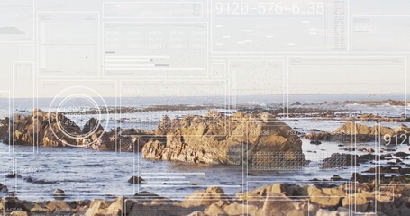 Revealing jagged rock clusters rising from ocean at low tide, with digital overlay panels and grids