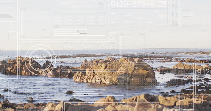 Revealing jagged rock clusters rising from ocean at low tide, with digital overlay panels and grids