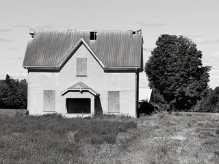 An old abandoned and decrepit home on a farm