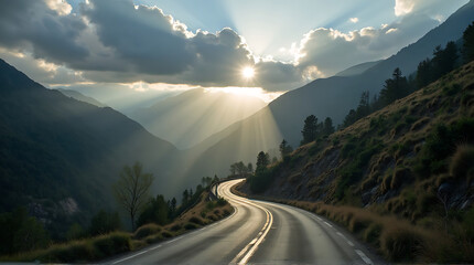 Scenic mountain road winding through a valley with sun rays piercing clouds