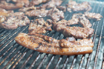 Menu Thai famous food grilled pork on an iron grill.