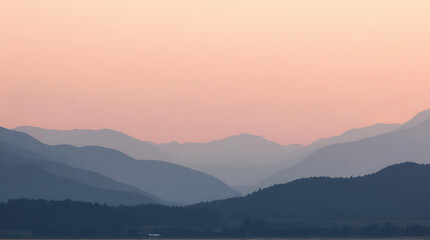 Fototapeta premium Serene layered mountain range with soft pink sky at dusk, panoramic vista