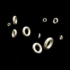 Golden rings floating on a black background