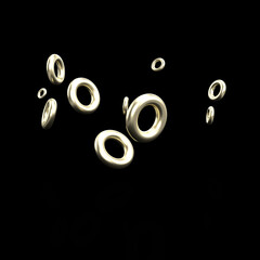 Golden rings floating on a black background
