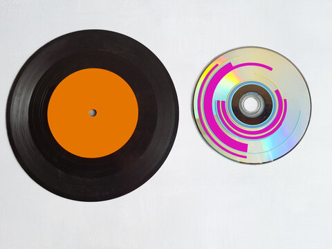 Vinyl record and cd rom on white background