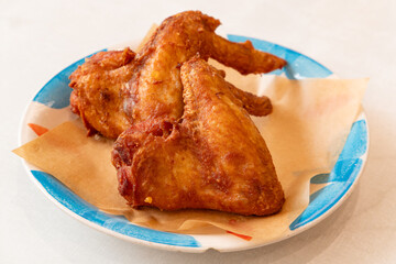 angle view deep fried chicken wings on a dish at horizontal composition