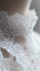 Obraz premium Elegant white lace detail on garment, showcasing intricate design and delicate craftsmanship.