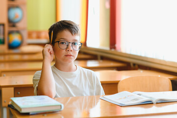 Thoughtful student pondering in classroom during lesson