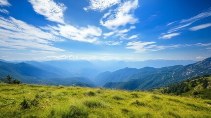 Naklejka premium The natural design of a breathtaking mountain range, showcasing green valleys and a vibrant blue sky.