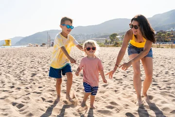 Fotobehang Happy beautiful asian family having fun at the beach during summertime © oneinchpunch
