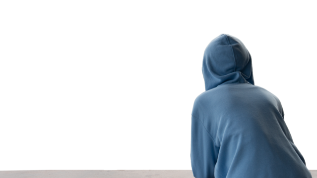 Rear view of a person in a blue hoodie looking towards a stark white background conveying solitude contemplation or anonymity. Ample copy space for design.