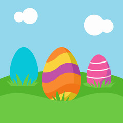 Three colorful easter eggs in a grassy field under a blue sky