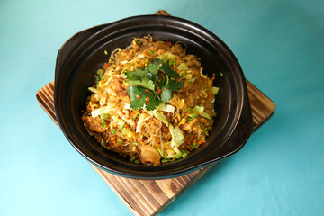 Sauteed Pork Lard and Wild Vegetables with stir fried vermicelli noodles in a Clay Pot side view of Asian cuisine