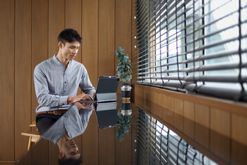 Businessman working on tablet in office
